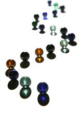 curved column of glass marbles on the white basis