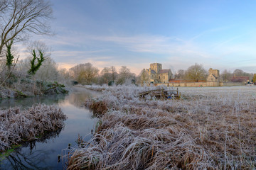 Frosty winter sunrise with a hoarfrost view of St Cross Hospital, Winchester, Hampshire, UK