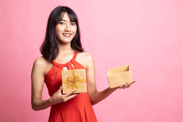 Young Asian woman open a golden gift box.