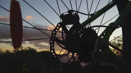 Spinning Bicycle wheel at sunset