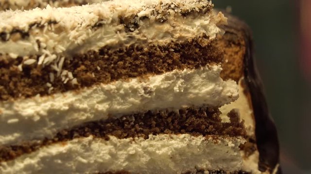 Closeup on a slice of a chocolate-and-cream cake on a baking sheet