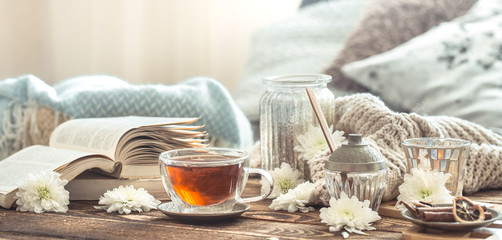 Still life details of home interior on a wooden table with a Cup of tea