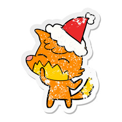 distressed sticker cartoon of a fox wearing santa hat