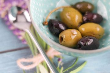 mixed olives on decorated table with copy space