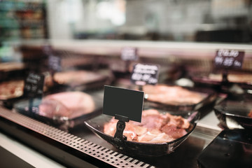 Shelf with fresh meat in food market, nobody
