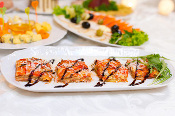 Tartlets with cheese and mushrooms on a festive table.