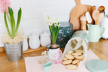 Baked easter cookies in metal container on wooden table in the kitchen
