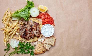Traditional turkish, greek meat food. Shawarma, gyros, kebab, souvlaki and tzatziki on pita bread