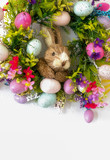 easter wreath with colorful eggs and flowers and a rabbit in the center