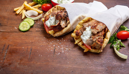 Gyro pita, shawarma, take away, street food. Traditional greek turkish, meat food on wooden table