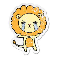 distressed sticker of a cartoon crying lion