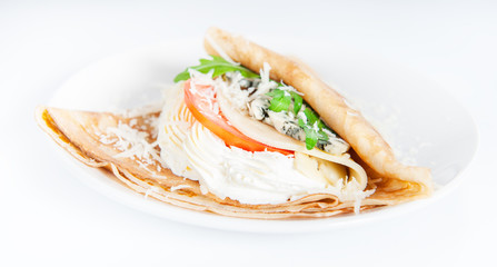 Thin delicious pancake with four types of cheese on white