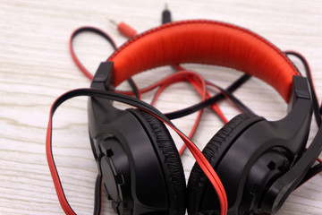 Black headphones on dark wooden background Vintage style .