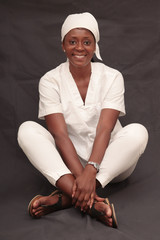 black nurse woman dressed in white coat with beautiful smile