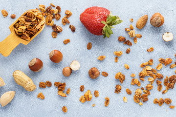 Granola, strawberries and ingredients - oats and various nuts.