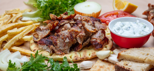 Gyros pita, Shawarma. Traditional greek, turkish meat food on pita bread and tzatziki, banner