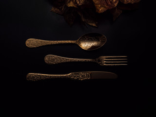 Gold cutlery with soft lighting and decoration