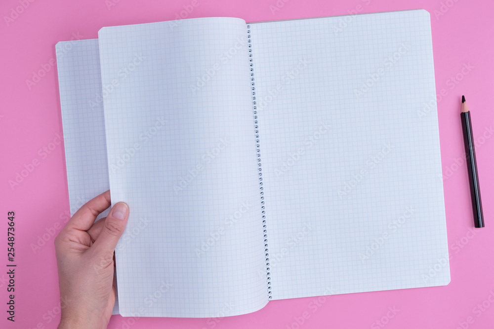Poster empty open notebook in a cell and a female hand