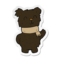 sticker of a cartoon waving black bear