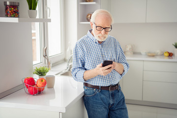 Close up portrait grey haired he his him grandpa hand arm watch see look telephone smart phone...