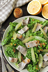 Fitness salad with lemon, lettuce and herring fillet. Fresh salad for weight loss. Ketogenic diet.