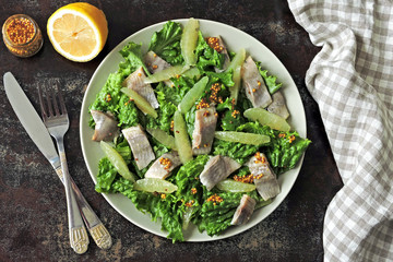 Fitness salad with lemon, lettuce and herring fillet. Fresh salad for weight loss. Ketogenic diet.