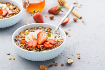 Bowl of granola or muesli with strawberry, banana and milk.