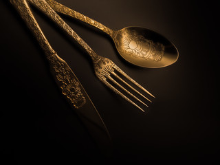 Luxury gold silverware set with soft lighting