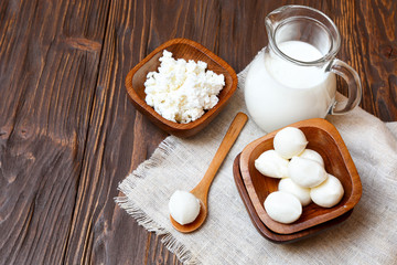 Mozzarella cheese in a wooden bowl on the  table