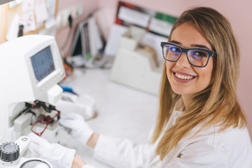 woman ophthalmologist working in optics store
