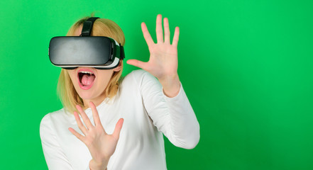 Funny woman experiencing 3D gadget technology - close up. Woman using virtual reality headset. Happy woman exploring augmented world, interacting with digital interface. VR games.