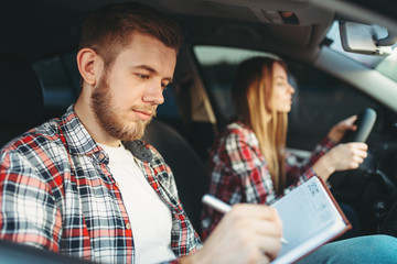 Male instructor and female student, driving lesson
