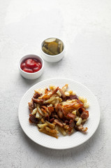 Crispy pan fried potatoes with pork, pickles and tomato ketchup sauce