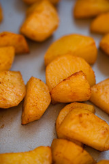 Close up of baking tray with Patatas Bravas, a traditional Spanish tapas dish, potato cubes or wedges roasted, baked or deep fried until tender and cripsy on the outside