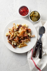 Crispy pan fried potatoes with pork, pickles and tomato ketchup sauce
