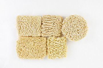 Different Asian raw dried egg noodles on white background