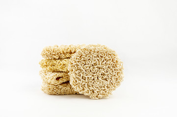 Heap of different Asian raw dried egg noodles on white background