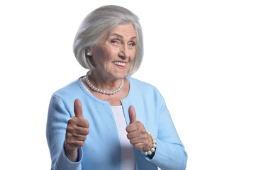 Portrait of beautiful senior woman showing thumbs up