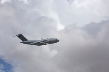 Naklejka na ściany i meble Military plane and cloudscape in Tropical North Queensland, Australia