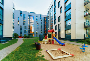 Modern residential apartment flat house building and children playground
