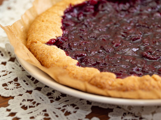 Cherry pie on a white openwork napkin.