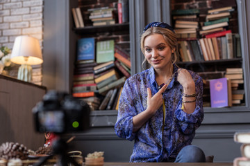 Delighted cheerful woman showing a beautiful talisman