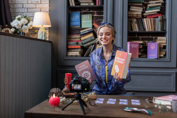 Pleasant blonde young woman speaking about books