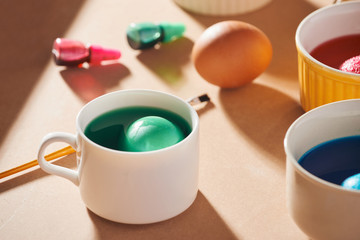 A dozen eggs in a carton, used watercolor paints.