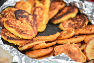 A lot of pancakes on a plate in the kitchen. Cooking workshop.