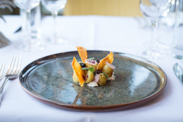 Delicate potato and crispy chicken skin starter