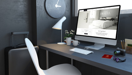 navy desktop with travel accesories and lgrand hotel website