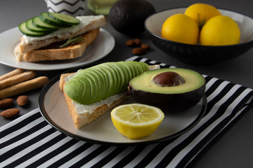 Healthy avocado breakfast. Sliced avocado on toast bread with spices, lemons. Dieting, food. Morning food.