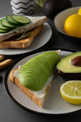 Healthy avocado breakfast. Sliced avocado on toast bread with spices, lemons. Dieting, food. Morning food.