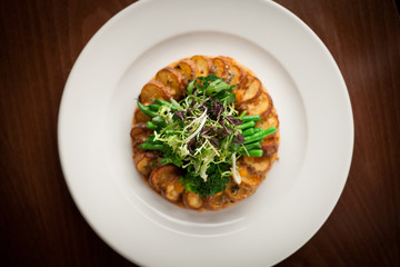 Greens and potato dish on white plate